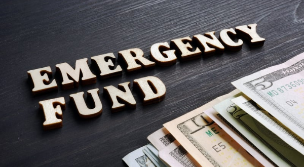 Person setting up automatic transfers to an emergency fund account