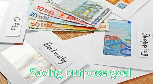 Person writing down their savings goals and purposes